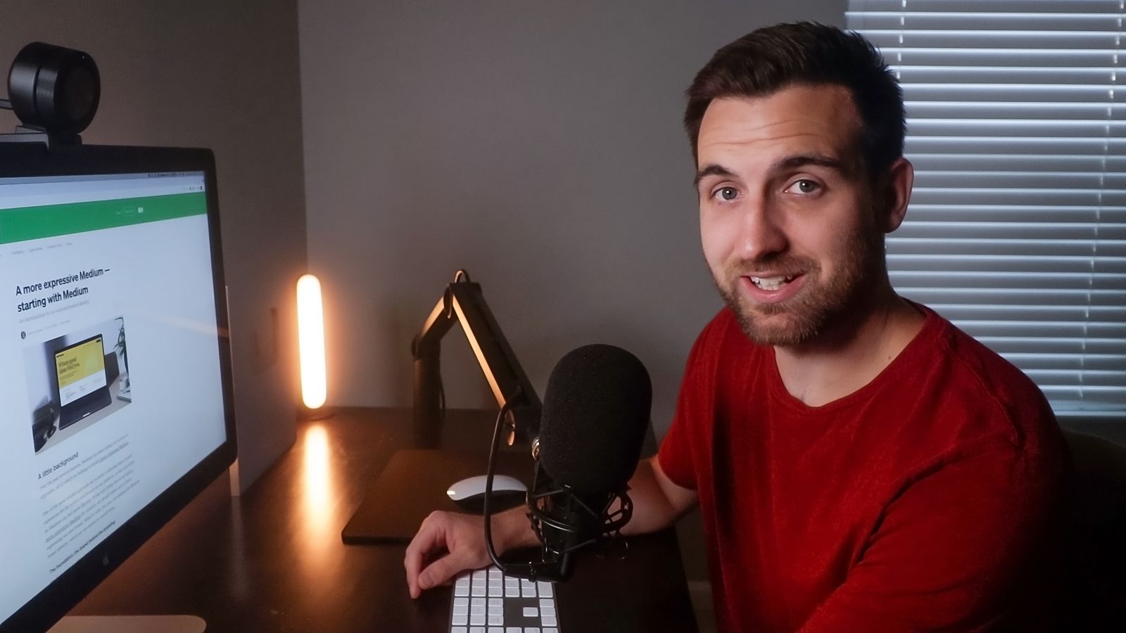 Spencer at his desk with an XLR mic and Apple Studio Display