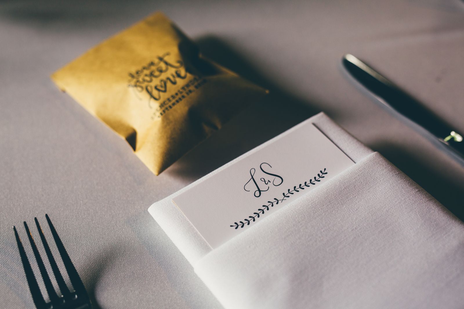 Wedding menu card and napkin with monogram on a table setting
